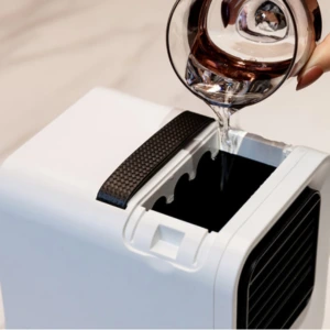 Image of filling up Chiller Portable AC with water with a glass